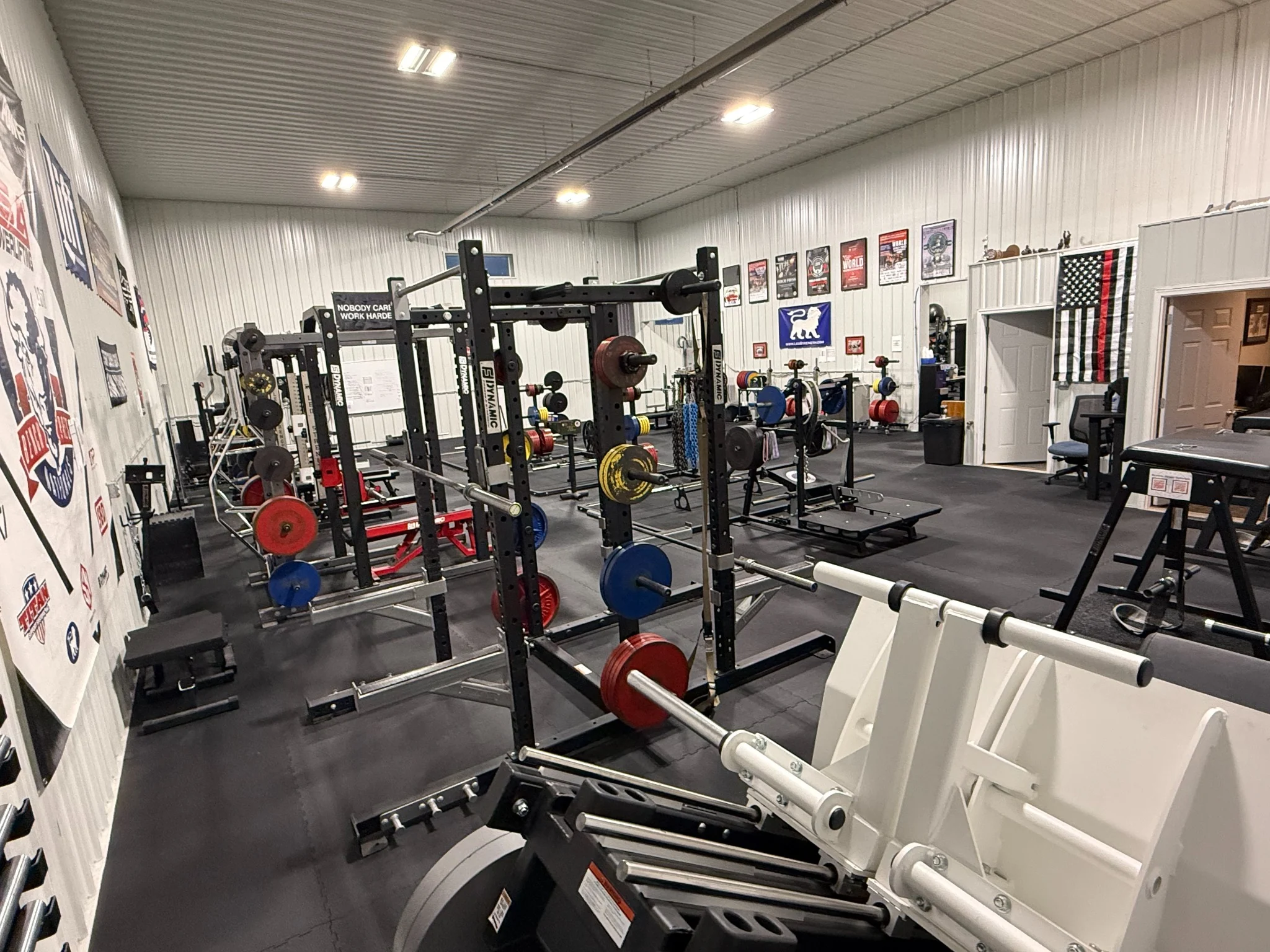 Actual Liberty Barbell weight training area with squat racks and calibrated plates